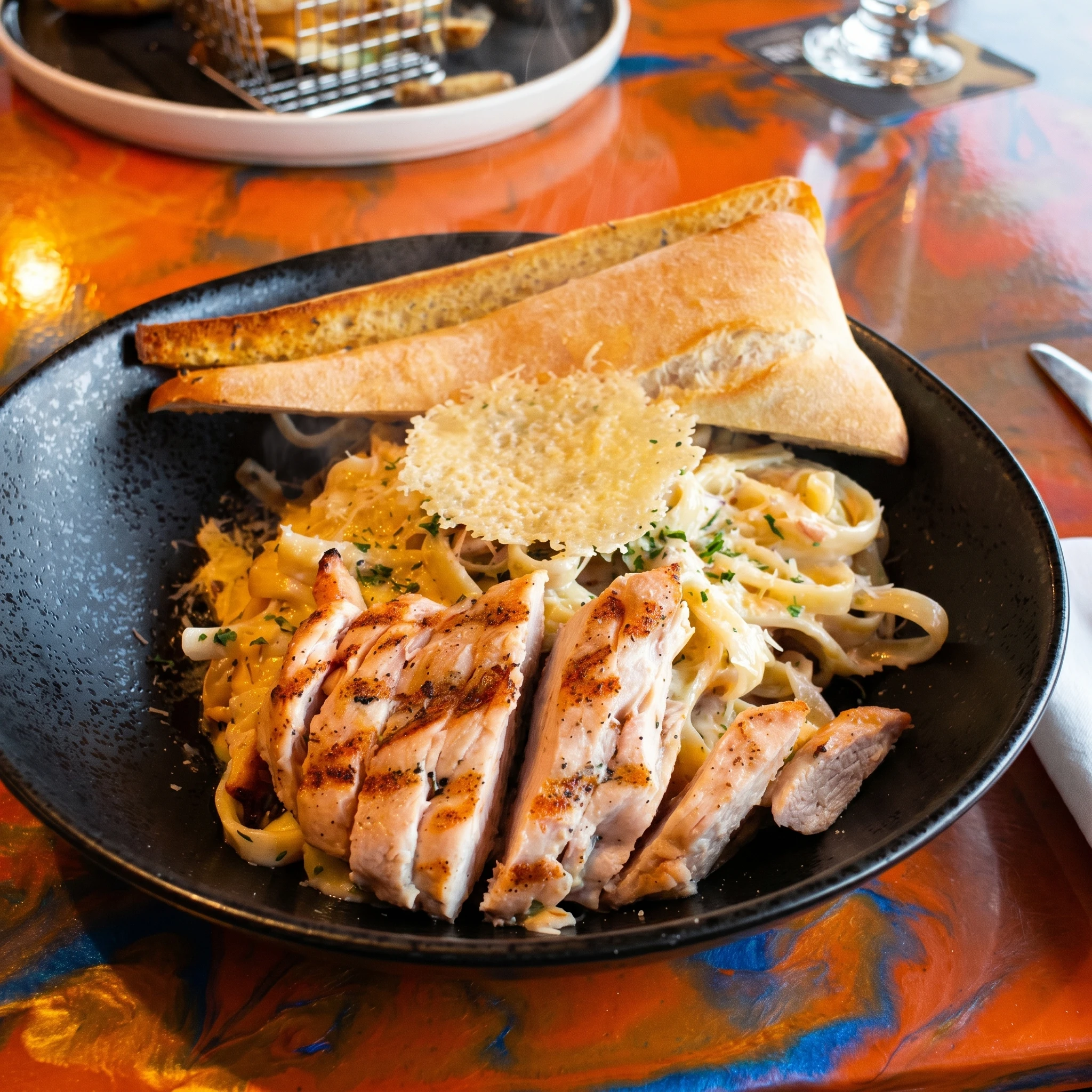 Fettuccine Alfredo with grilled chicken at Bizarre Gastro Pub Calgary SE